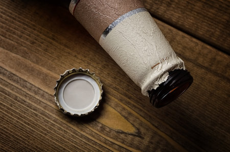 Beer bottle and cork on a wooden backgroundの写真素材