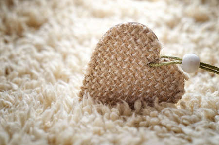 Christmas decoration of little heart close-up on carpetの写真素材