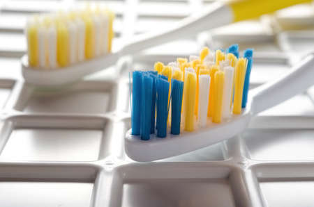 Tooth brush on plastic checkered backgroundの写真素材