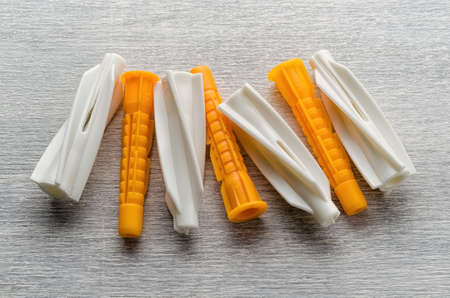 Wall plugs, Dowels, Wall anchors on wooden backgroundの写真素材