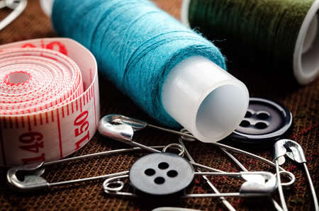 Reel of thread, buttons and pins for sewing and needlework