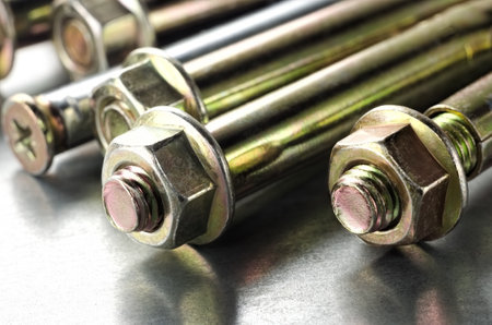 Anchor bolts closeup on a metallic backgroundの写真素材
