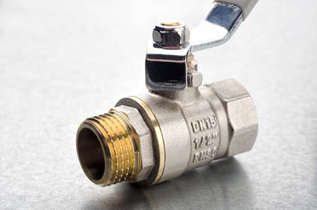 Brass water ball valve close up on metallic backgroundの写真素材