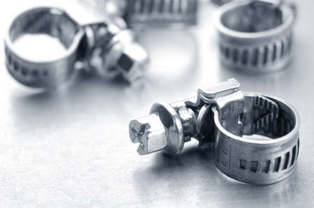 Screw clamps on a metallic background closeupの写真素材