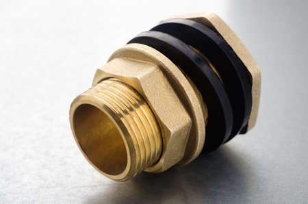 Brass fitting connector on a metallc backgroundの写真素材
