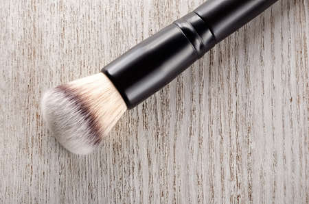 Cosmetic brush closeup on a wooden table.Top viewの写真素材
