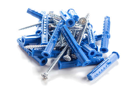 Wall plugs, dowels, screws and anchors closeup on a white backgroundの写真素材