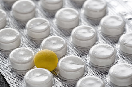 Blister of pills closeup. Single yellow pillの写真素材