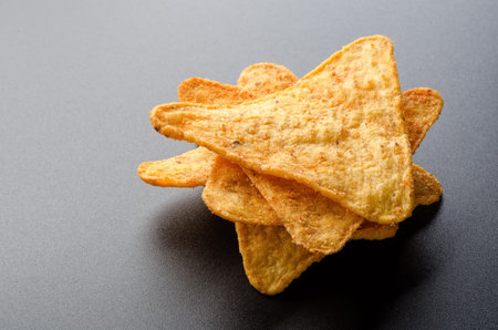 Stack of the chips corn on a black backgroundの写真素材