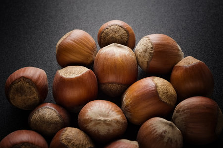 Hazelnut group closeup on a black backgroundの写真素材