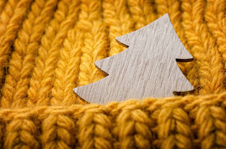 Wooden christmas fir on orange knitting textureの写真素材