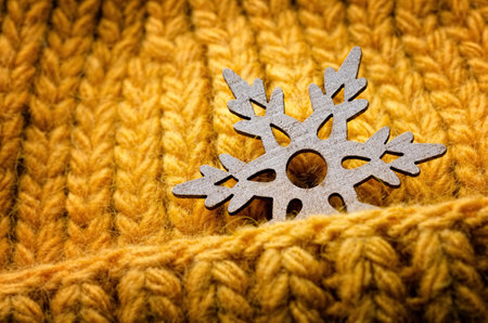 Wooden snowflake on a knitted orange backgroundの写真素材