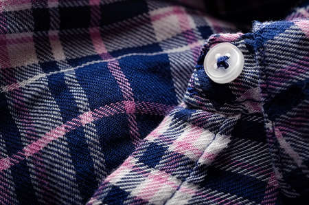 Button on a checkered shirt close-upの写真素材