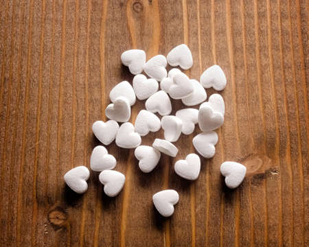 Pills as a heart form closeup on a wooden backgroundの写真素材