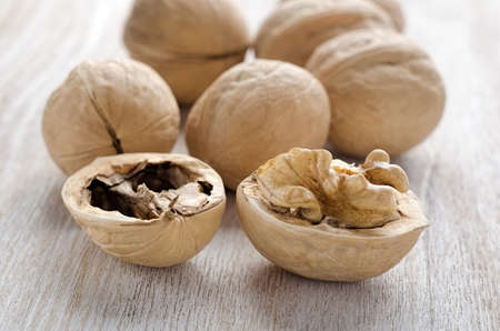 Broken walnuts on a wooden backgroundの写真素材