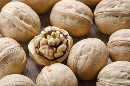 Broken walnuts on a wooden backgroundの写真素材