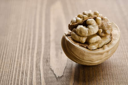Broken walnut on a wooden backgroundの写真素材