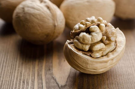 Broken walnut on a wooden backgroundの写真素材