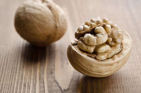 Broken walnuts on a wooden backgroundの写真素材