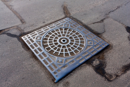 nmhole on urban roadの写真素材