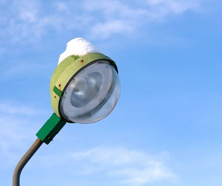 street lamp with snow on blue sky backgroundの写真素材