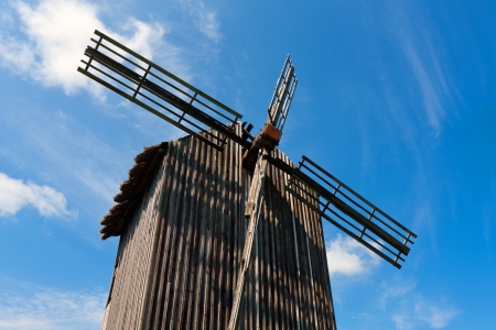 Old wooden windmil on blue sky backgroundの写真素材
