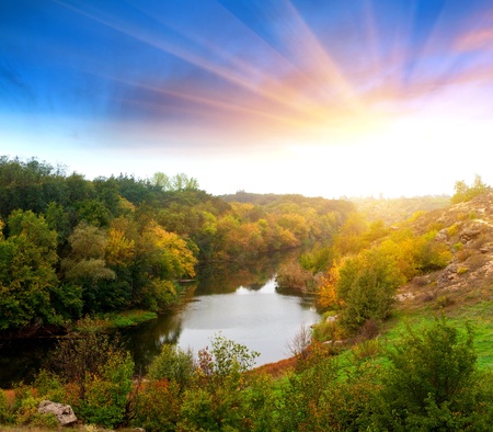 Autumn landscape with river in evening timeの写真素材