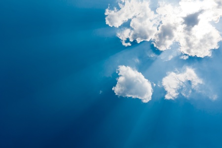 Nice clouds with sun rays in blue sky