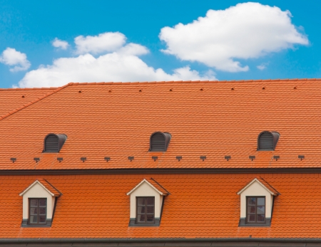 Nice red roof on nice sky backgroundの写真素材