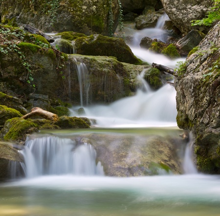Small waterfall on mountain brookの写真素材