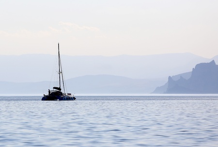 boat on the sea with mountains backgroundの写真素材