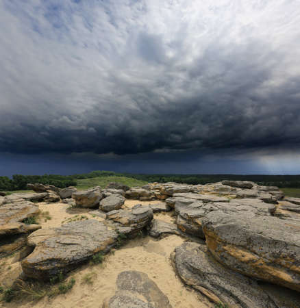 stones in desert on storm sky backgroundの写真素材