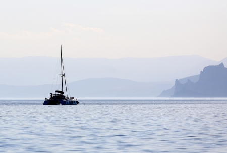 boat on sea on mountains backgroundの写真素材