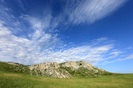 green meadow in mountains under nice skyの写真素材