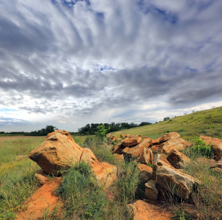Old stones  in steppe under dramatic skyの写真素材