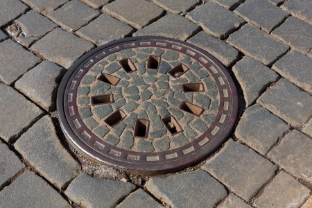 manhole on pavement in sunny dayの写真素材