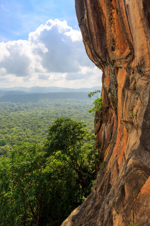 rocky wall of Sigiriya castle over jungleの写真素材