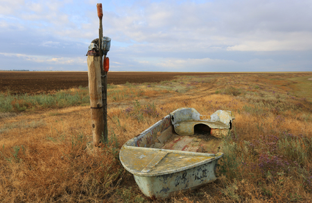old brocken ship on grass near sea shoreの写真素材