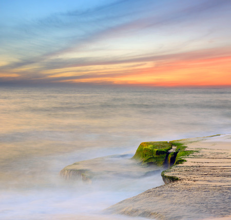 Stones in ocean on sunset backgroundの写真素材