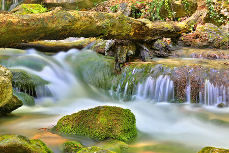 Nice small waterfall on mountain riverの写真素材