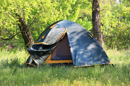 tourist tent on meadow in spring forestの写真素材