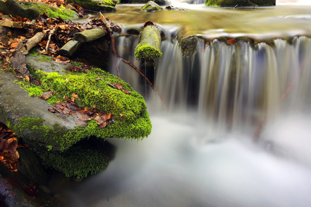 run of mountain river among green stonesの写真素材