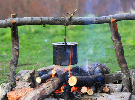 smoked tourist kettle over campfire の写真素材