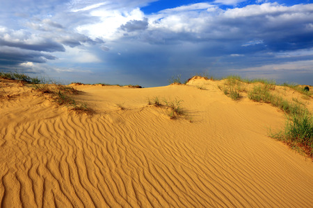 landscape with sands in desert under nice evening skyの写真素材