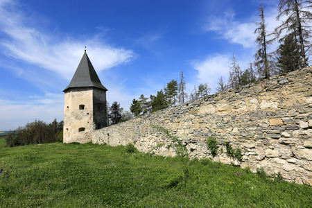 Old tower and wall of fortress in forestの写真素材