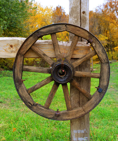 old wooden wheel on fence in ukrainian village

の写真素材