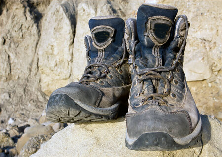 Tourists boots on stone in mountainsの写真素材
