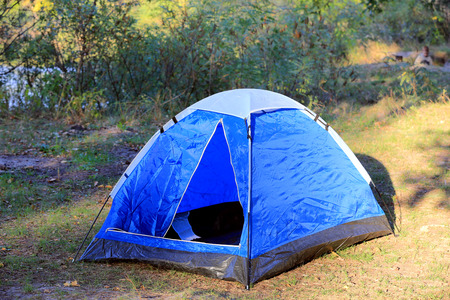 Tourist tent in forest meadowの写真素材