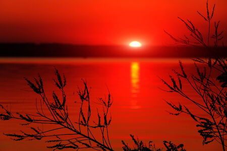 Red sunset on lake surfaceの写真素材