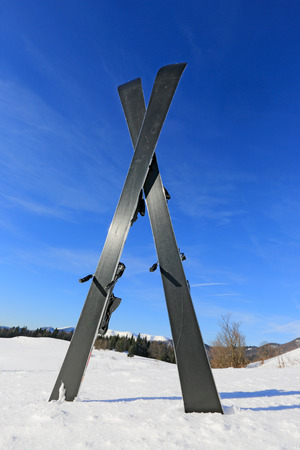 ski on winter field against blue skyの写真素材